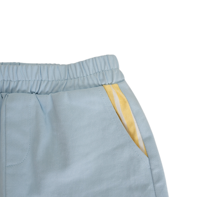 Light blue pants with a yellow stripe on a white background