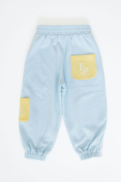 Light blue children's pants with yellow patches on a white background