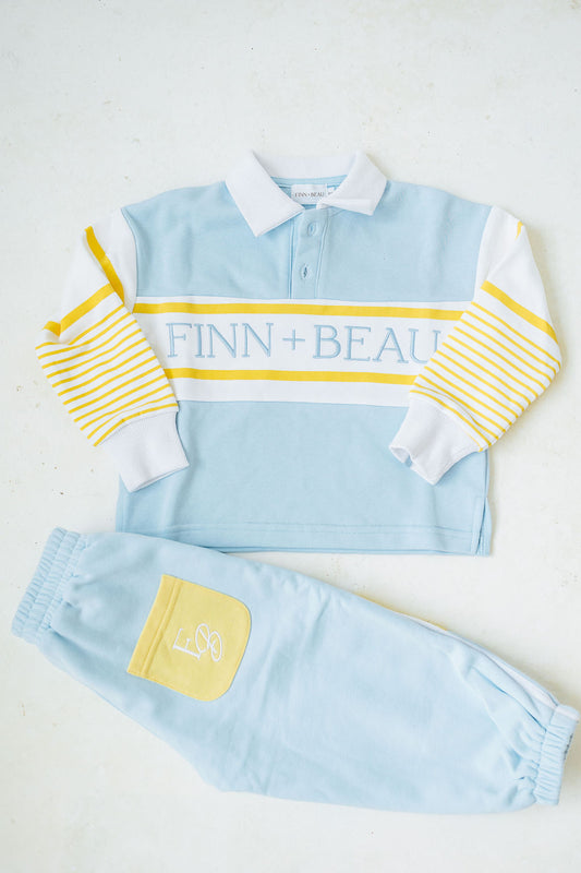 Children's light blue and yellow outfit with 'FINN + BEAU' branding on a white background