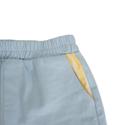 Light blue pants with a yellow stripe on a white background